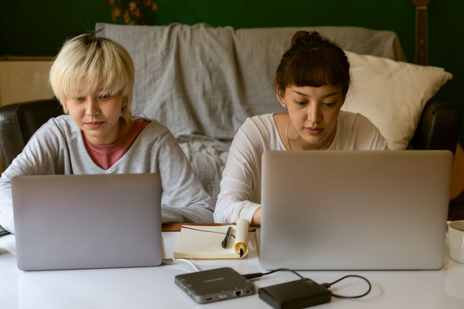 穏やかな雰囲気の中でノートパソコンを使い、仕事に集中している二人の女性。